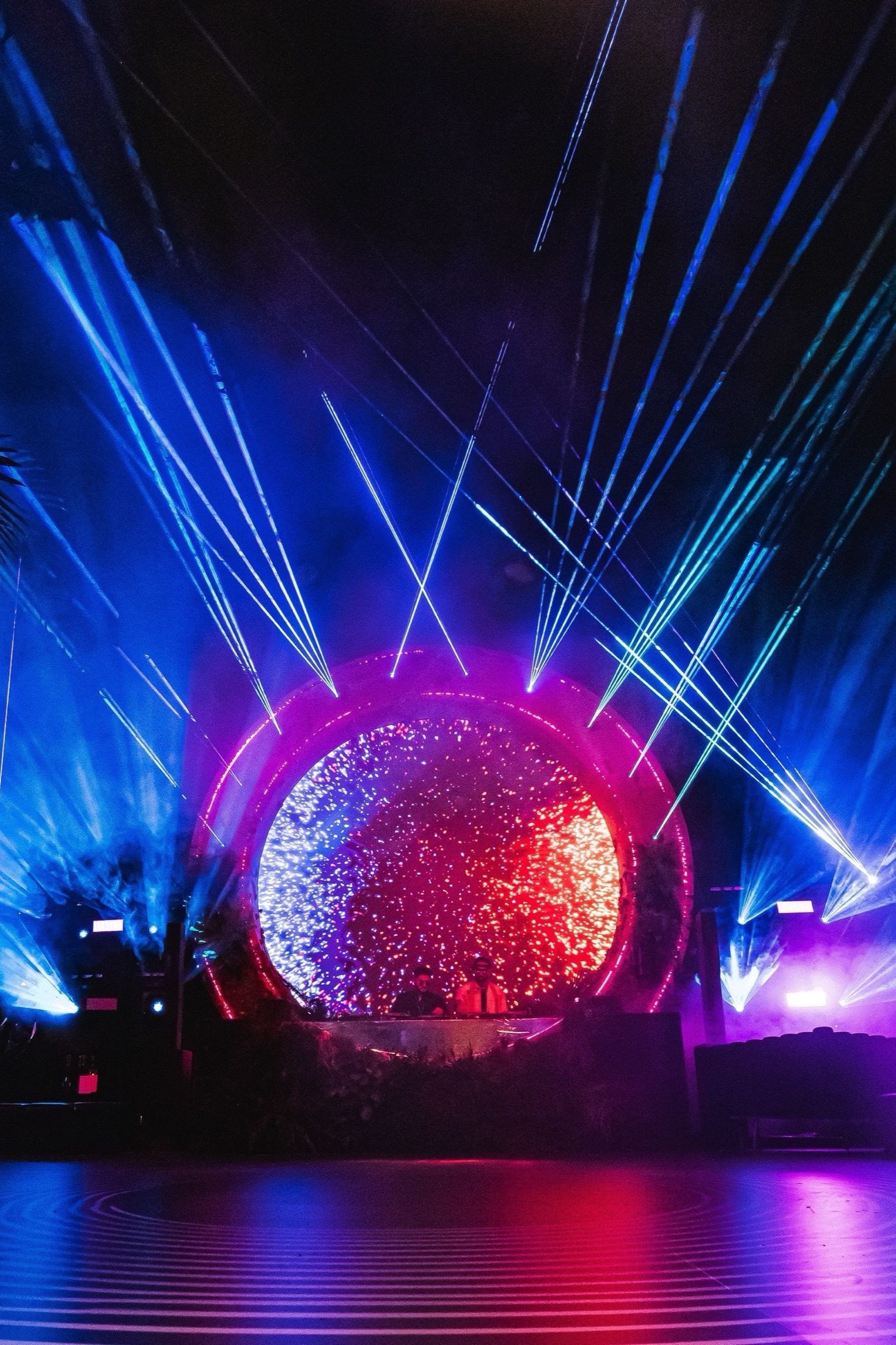 Circular stage with lasers and immersive scenic lighting